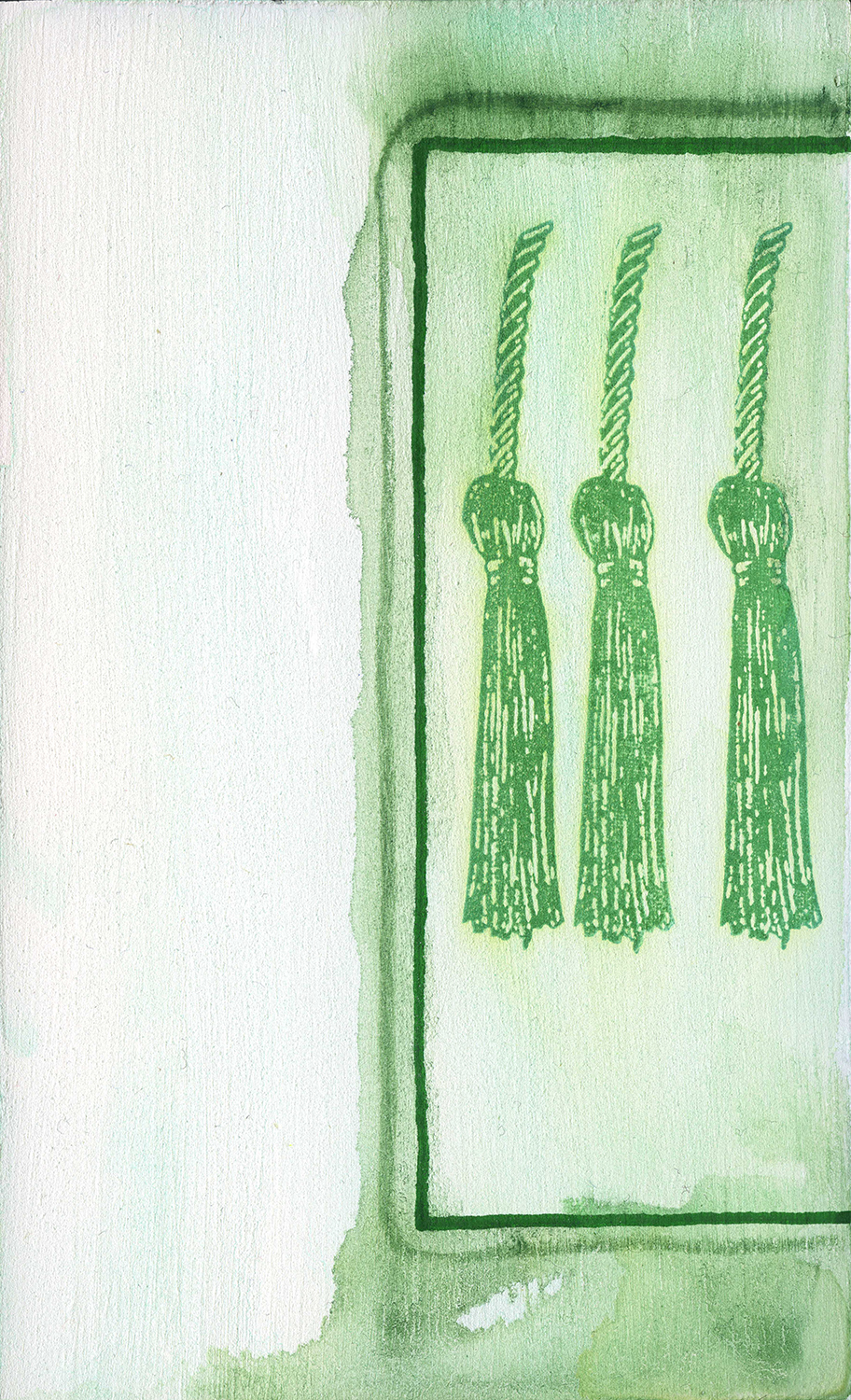 Three green tassels in a box