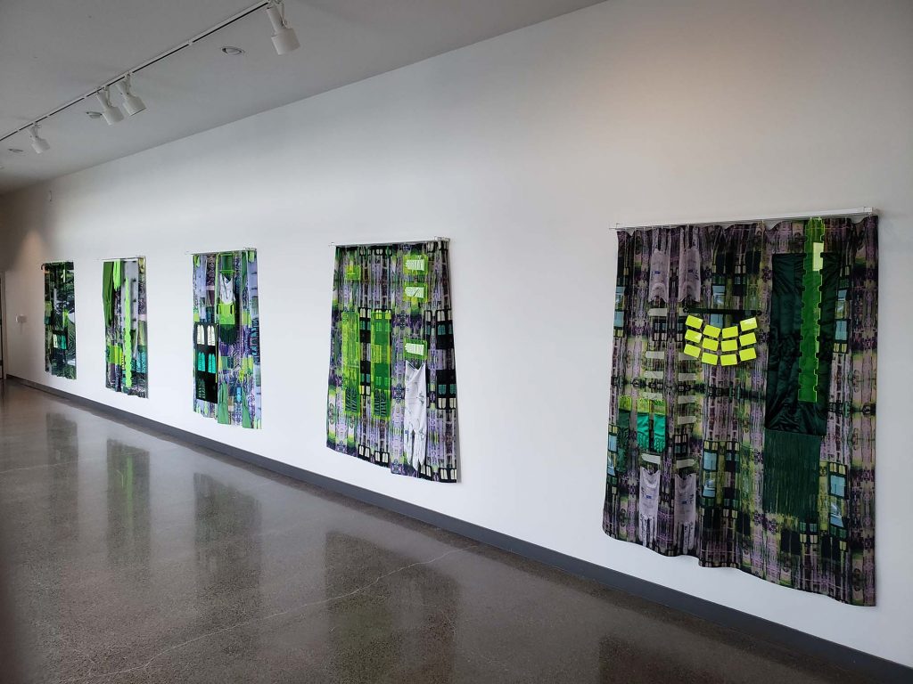 six green curtain artworks hanging on a white wall