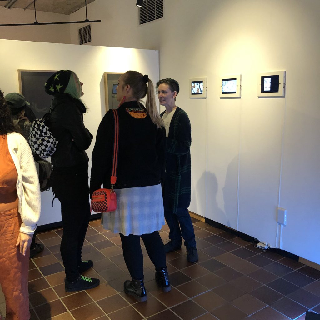 people talking in a gallery