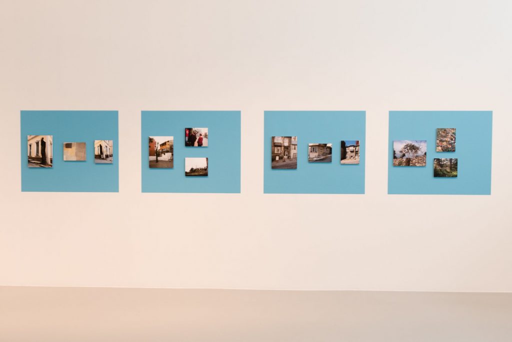 photographs on a wall in blue boxes